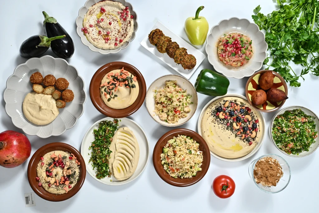 Benefits of Mediterranean Cuisine Traditional Lebanese mezze platter with hummus, tabbouleh, falafel, and fresh vegetables, showcasing the health benefits of Mediterranean food